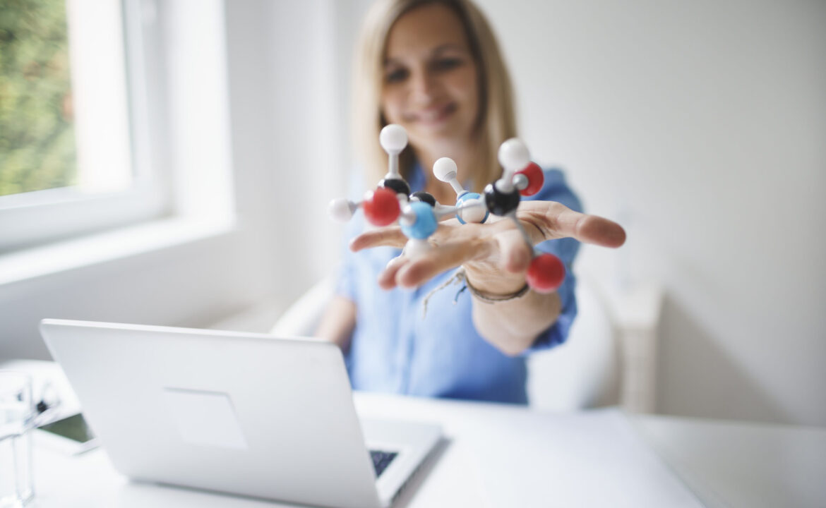 beautiful young woman with molecular model