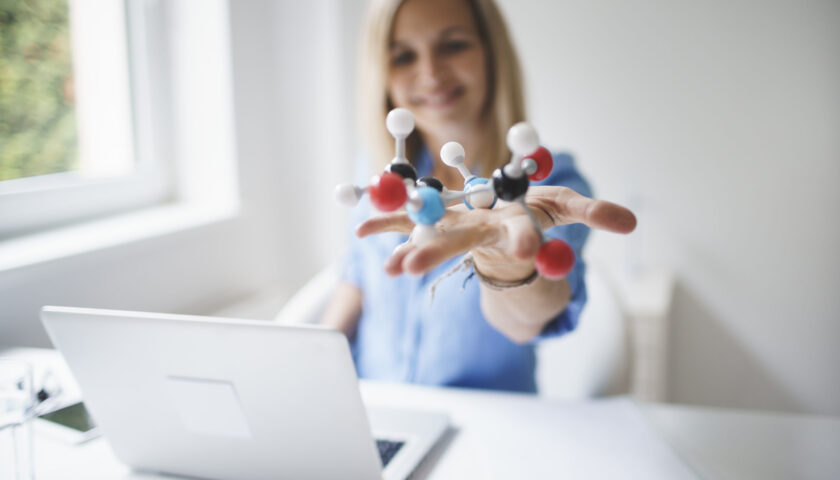 beautiful young woman with molecular model